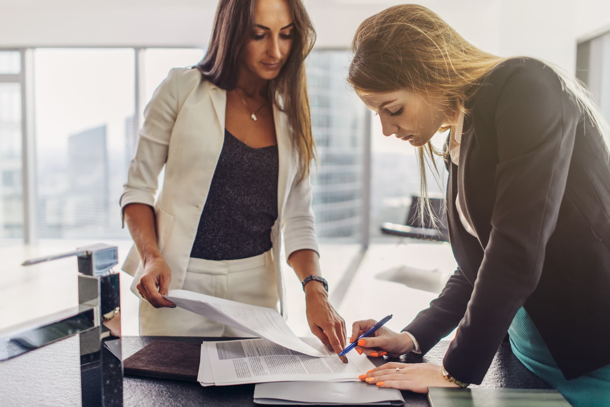 A notary guiding a client through signing a document